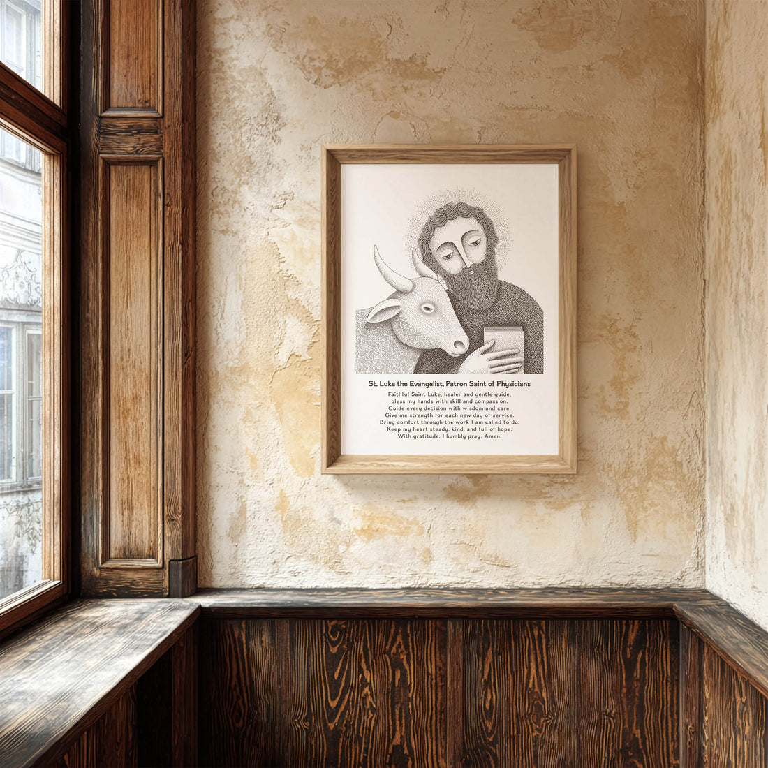 Brown St. Luke prayer print beside a wooden window on a textured wall.