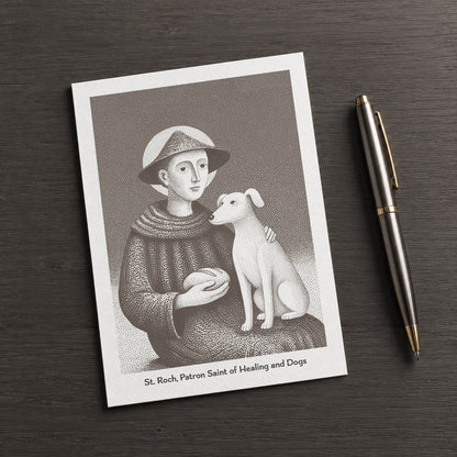Brown St Roch card on a dark table beside a pen