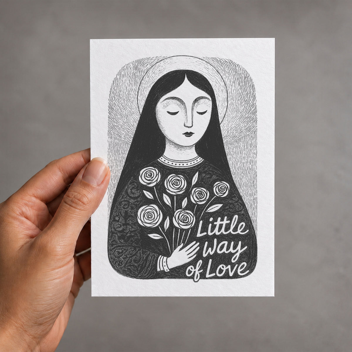 Black St. Thérèse of Lisieux card held in a hand, Little Way of Love illustration