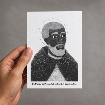 Black St Martin de Porres card held in a hand