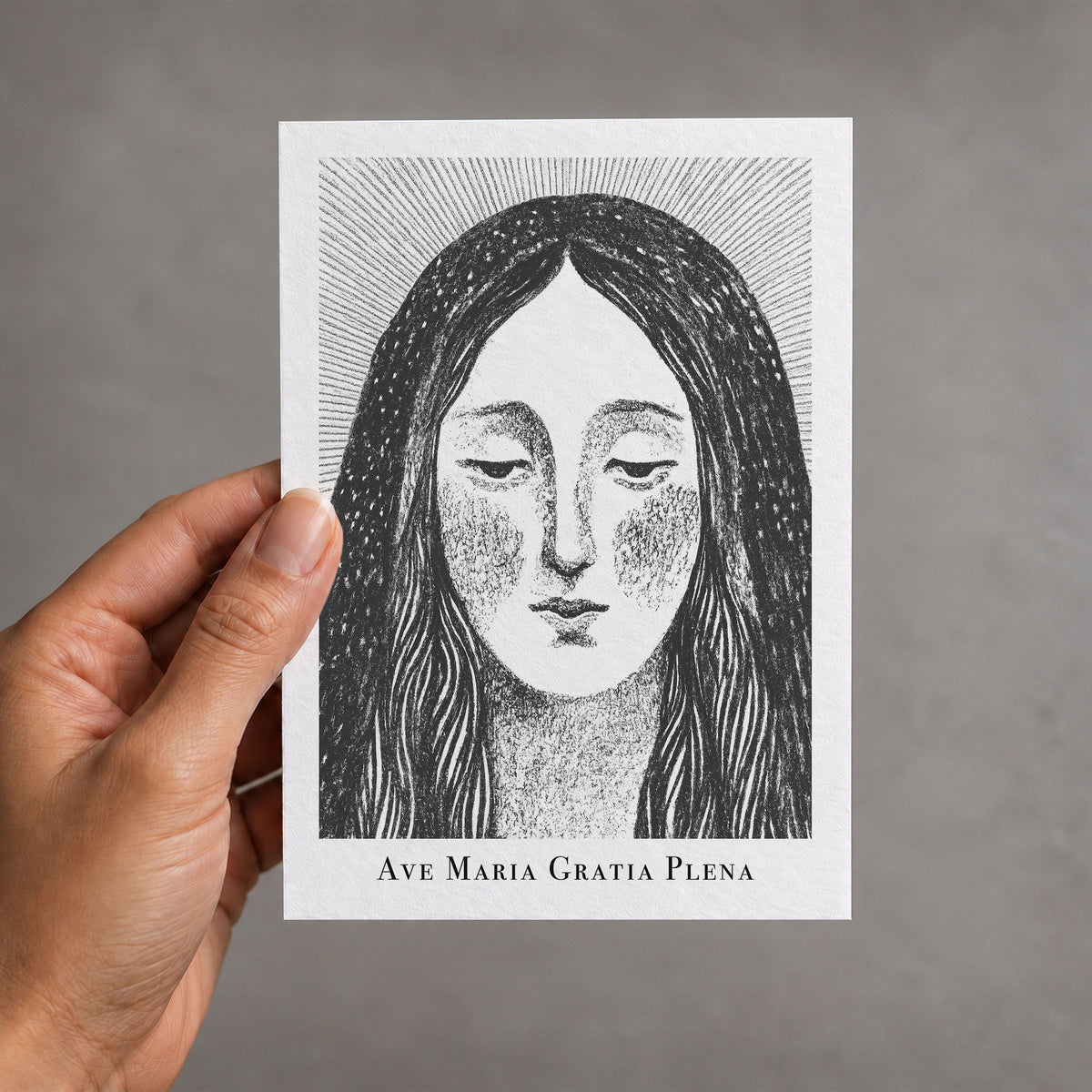 Black Virgin Mary card held in a hand