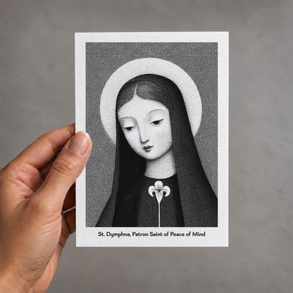 Black St Dymphna card held in a hand
