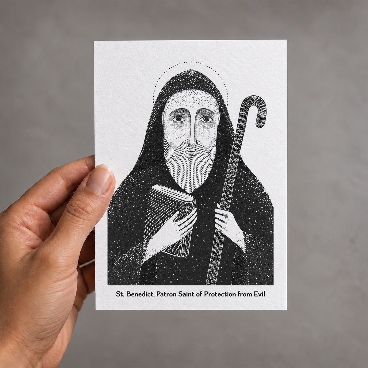 Black St Benedict card held in a hand