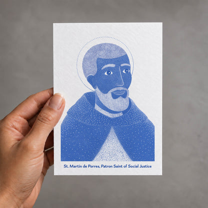 Blue St Martin de Porres card held in a hand