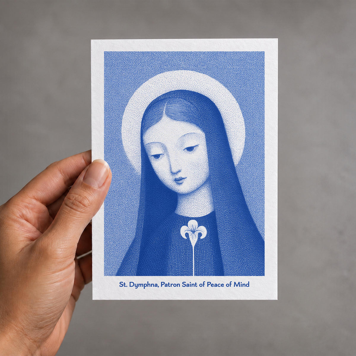 Blue St Dymphna card held in a hand