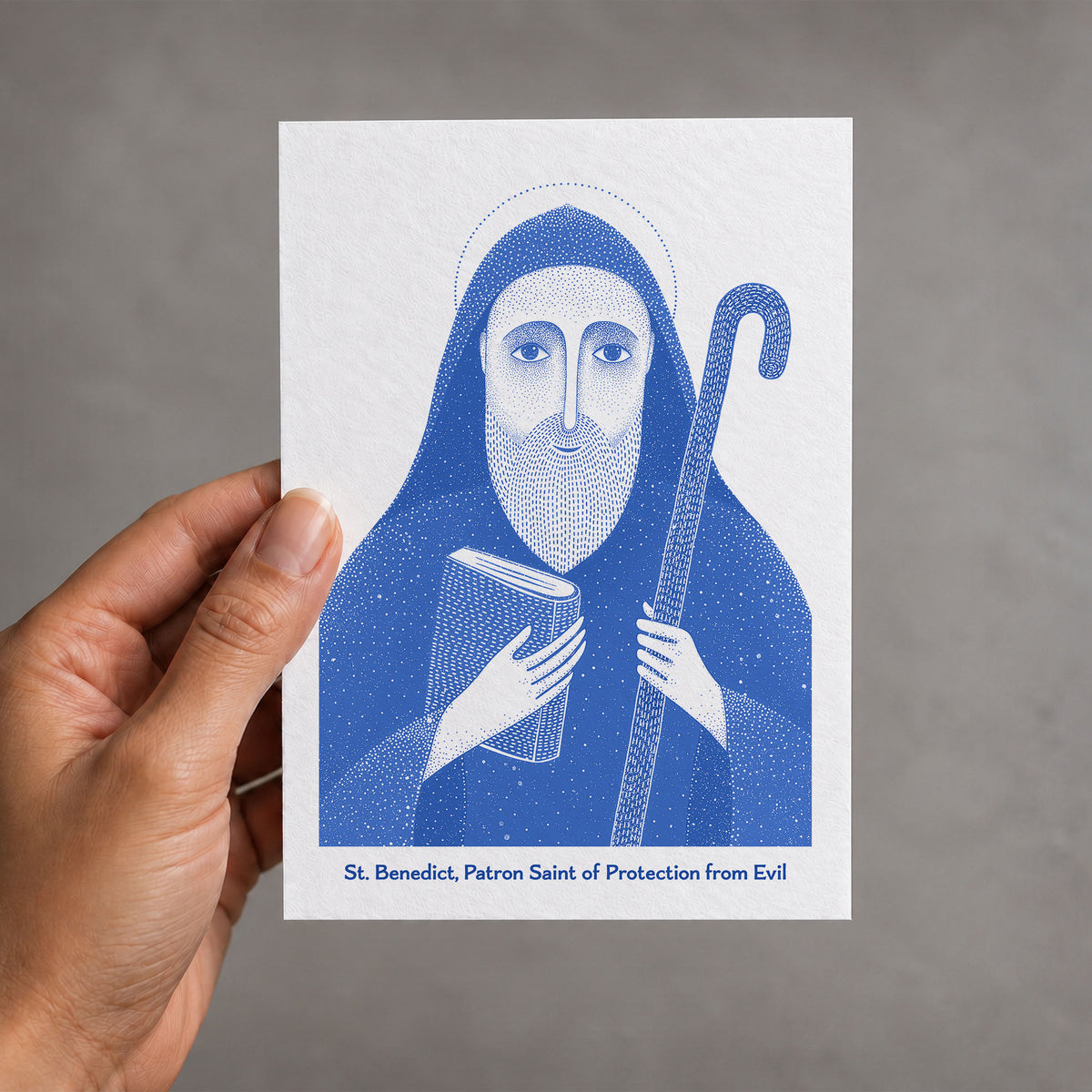 Blue St Benedict card held in a hand