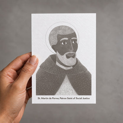 Brown St Martin de Porres card held in a hand
