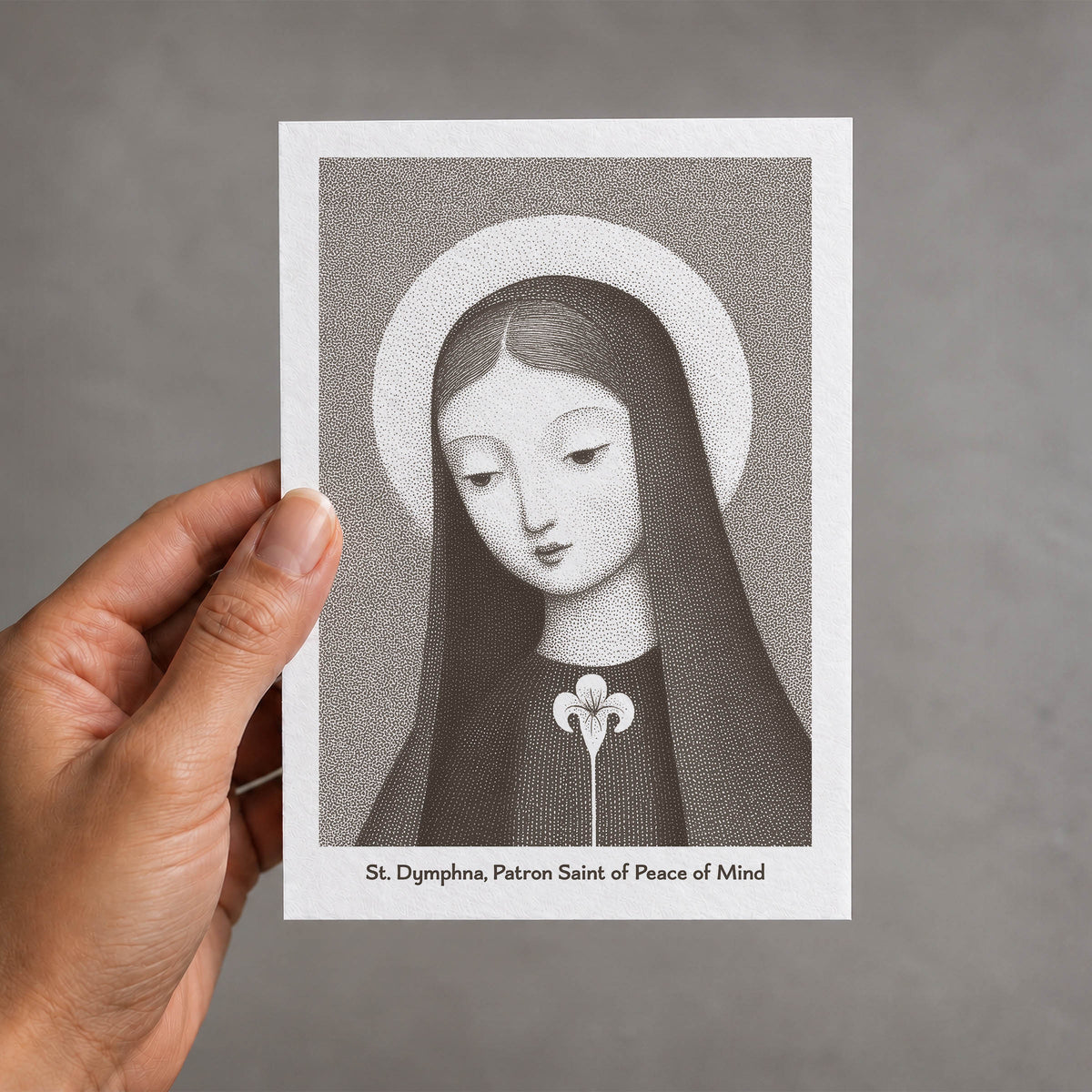 Brown St Dymphna card held in a hand