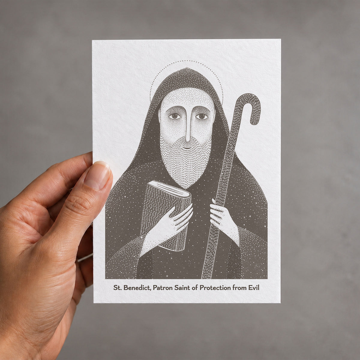 Brown St Benedict card held in a hand