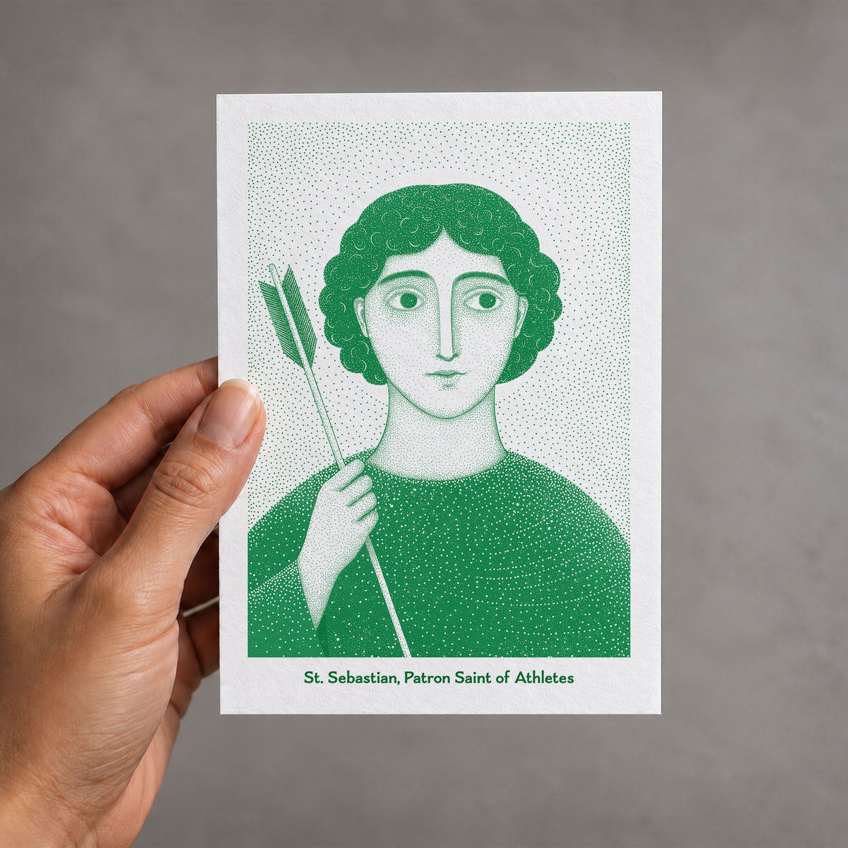 Green St Sebastian card held in a hand