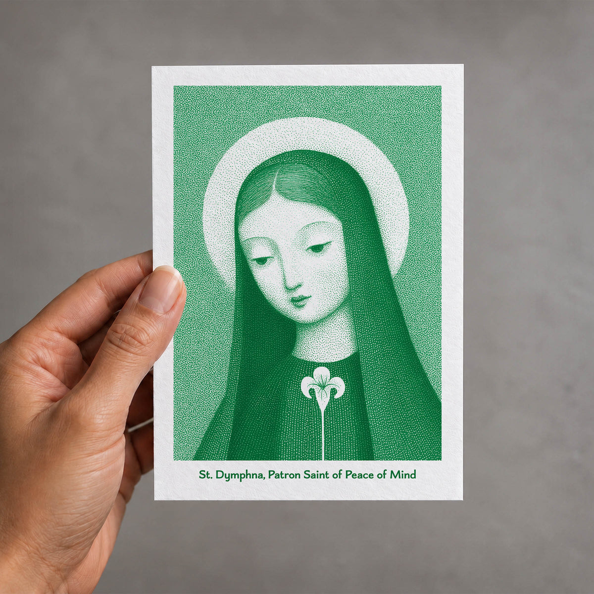 Green St Dymphna card held in a hand