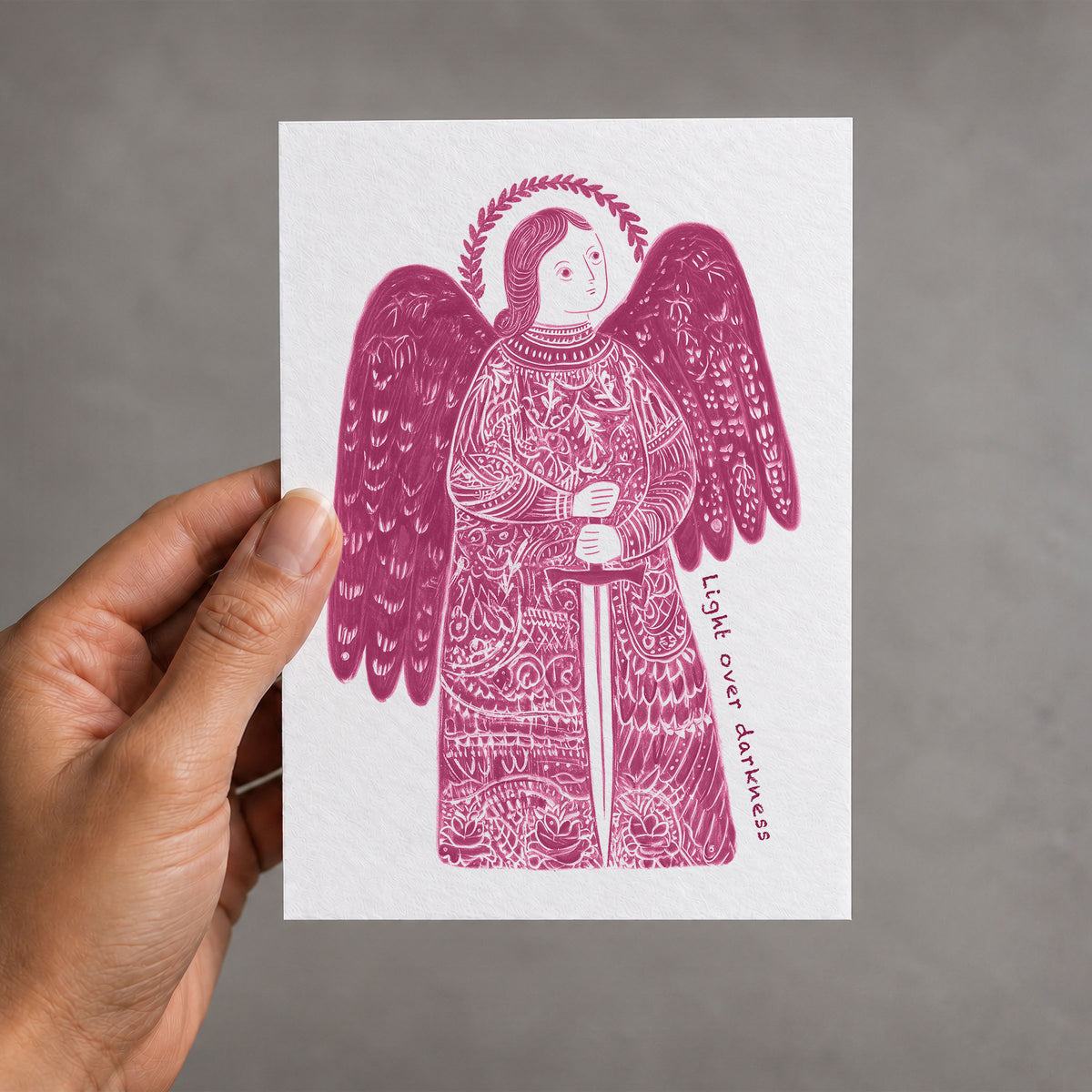 Pink St Michael the Archangel card held in a hand