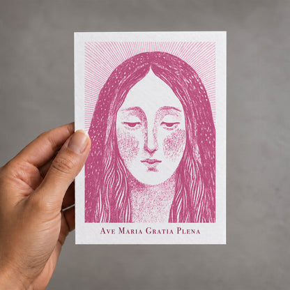 Pink Virgin Mary card held in a hand