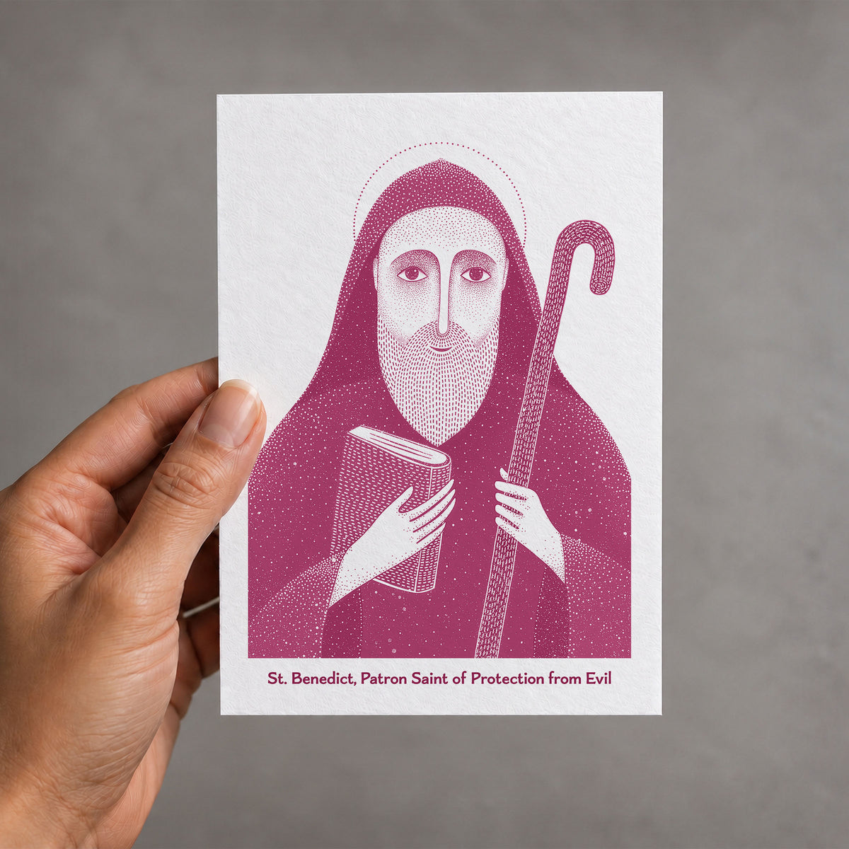 Pink St Benedict card held in a hand