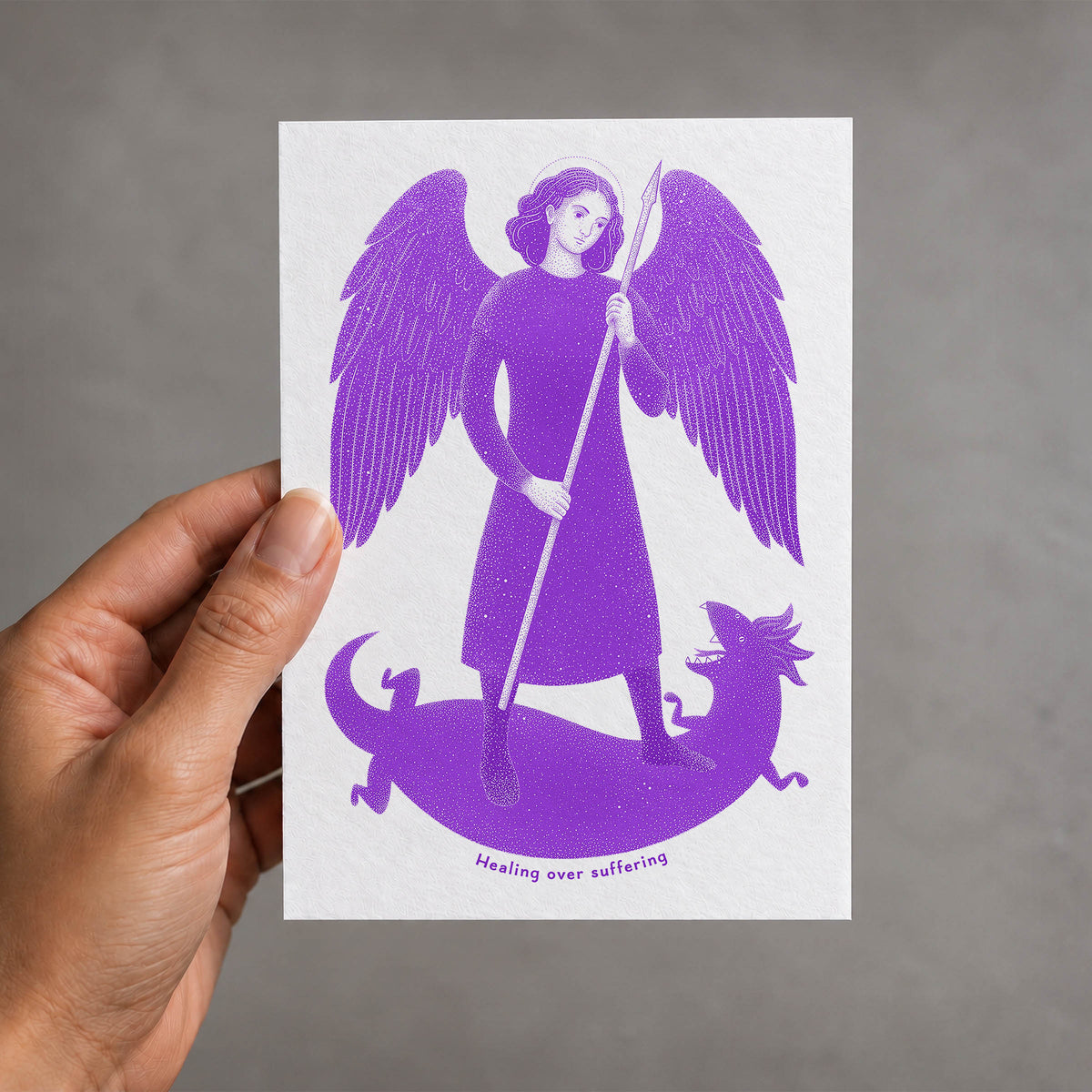 Purple St Raphael the Archangel card held in a hand