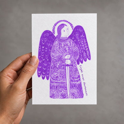 Purple St Michael the Archangel card held in a hand