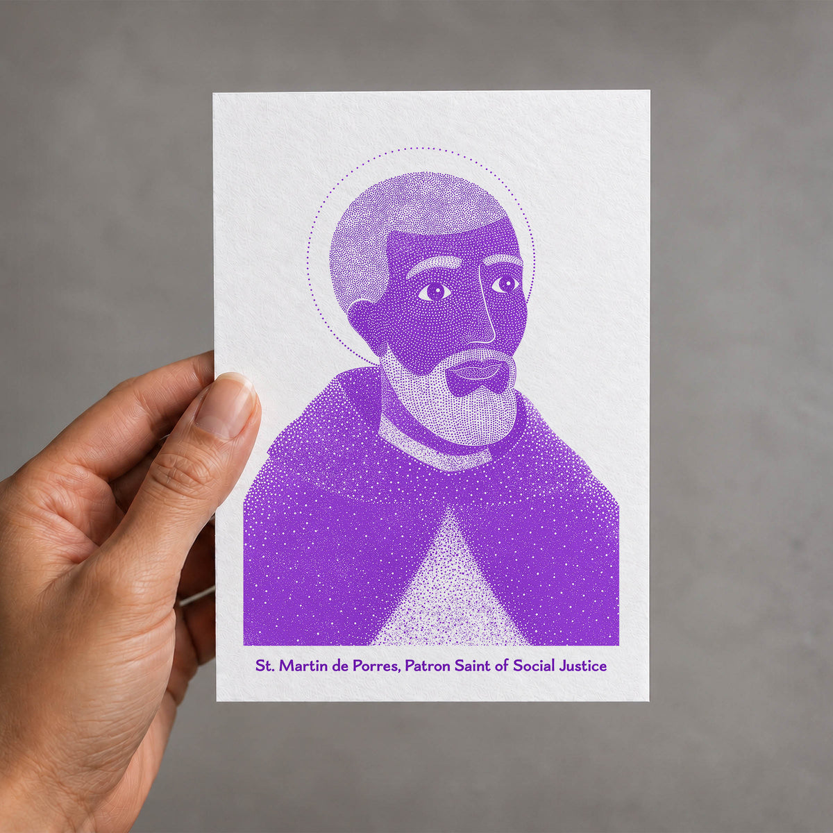Purple St Martin de Porres card held in a hand