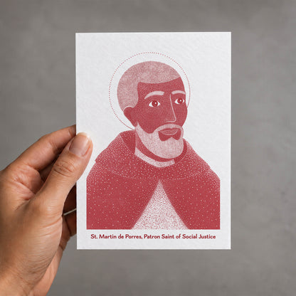 Red St Martin de Porres card held in a hand