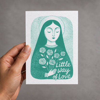 Teal St. Thérèse of Lisieux card held in a hand, Little Way of Love illustration