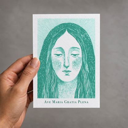 Teal Virgin Mary card held in a hand