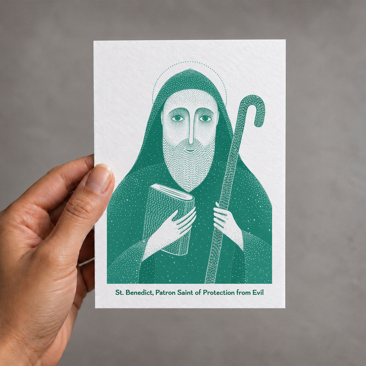 Teal St Benedict card held in a hand