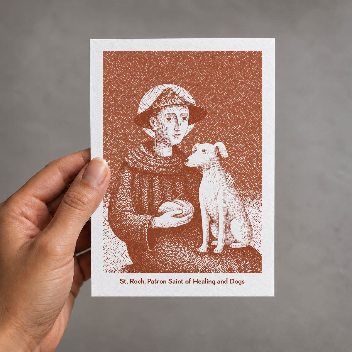 Terracotta St Roch card held in a hand
