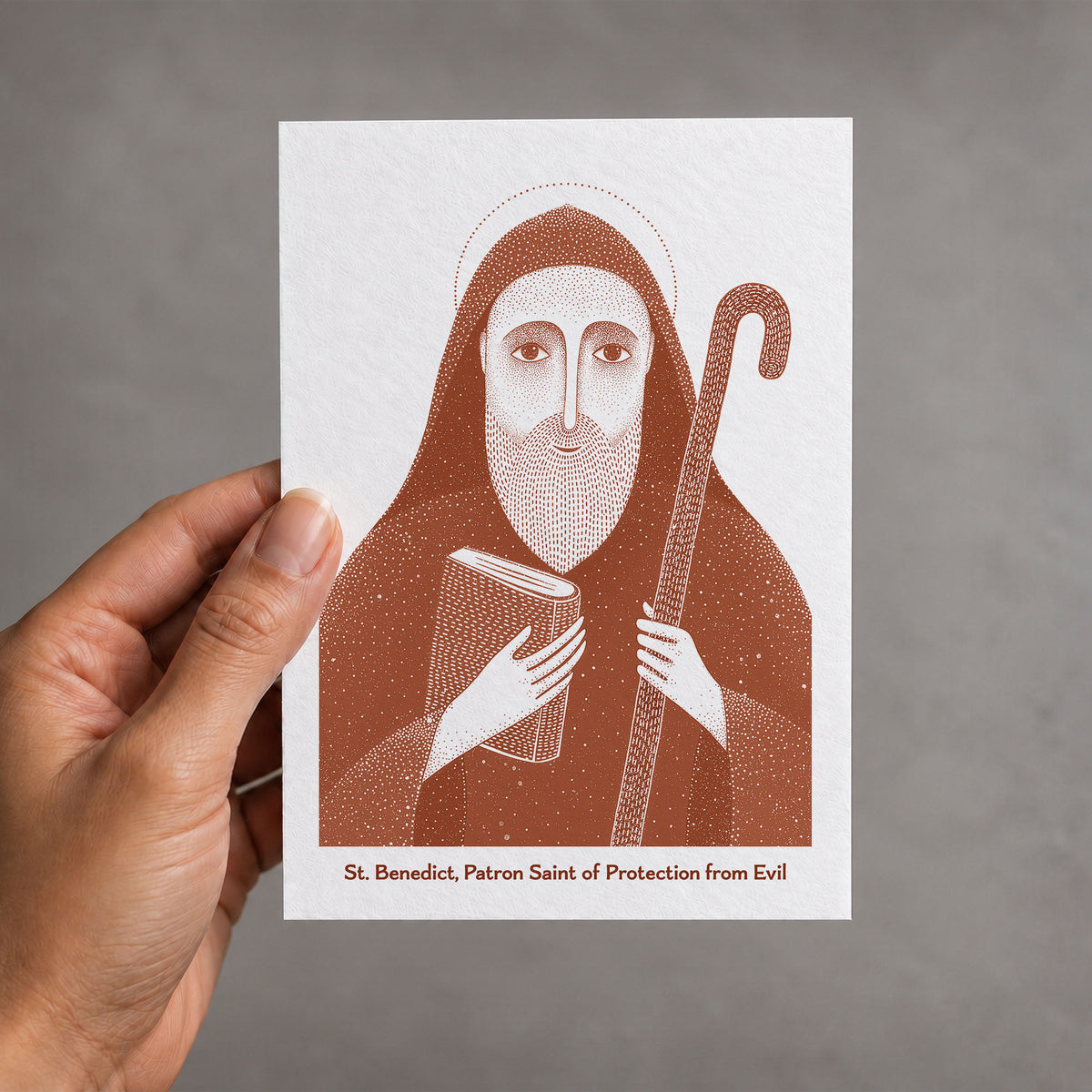 Terracotta St Benedict card held in a hand