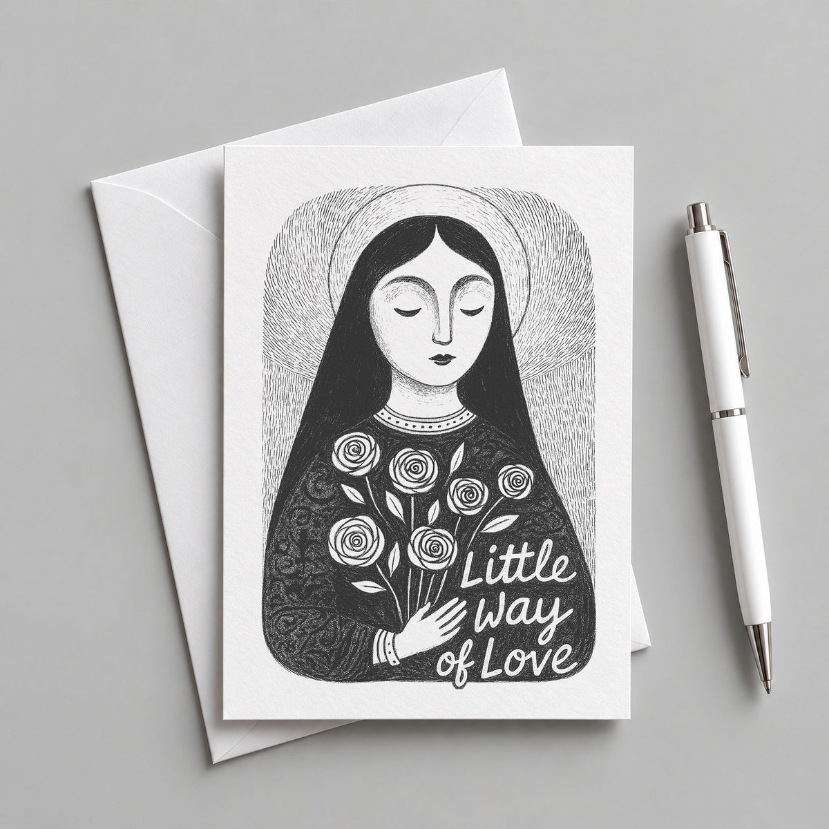 Black St. Thérèse of Lisieux card with an envelope and pen