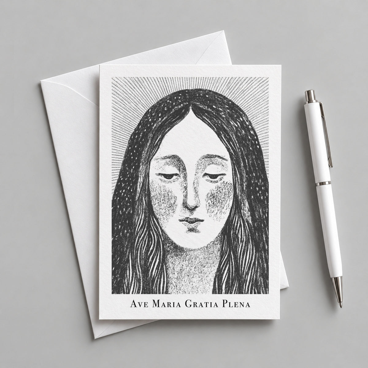 Black Virgin Mary card with an envelope and pen