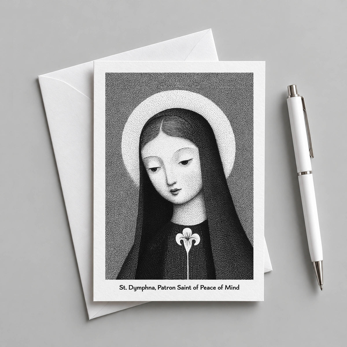 Black St Dymphna card with an envelope and pen