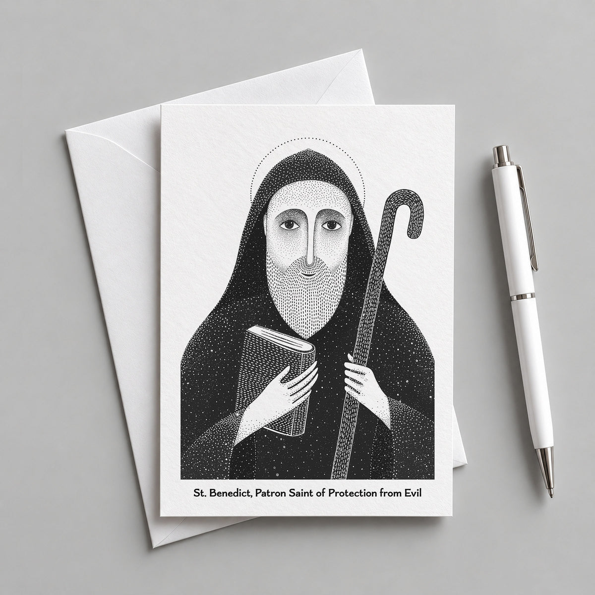 Black St Benedict card with an envelope and pen