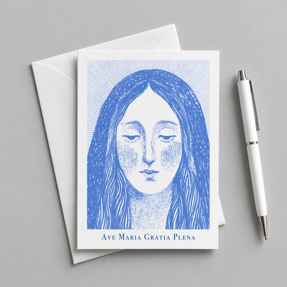 Blue Virgin Mary card with an envelope and pen
