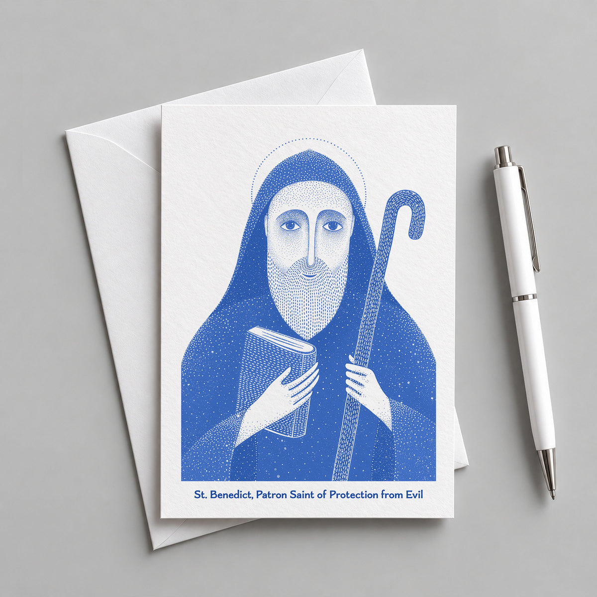 Blue St Benedict card with an envelope and pen