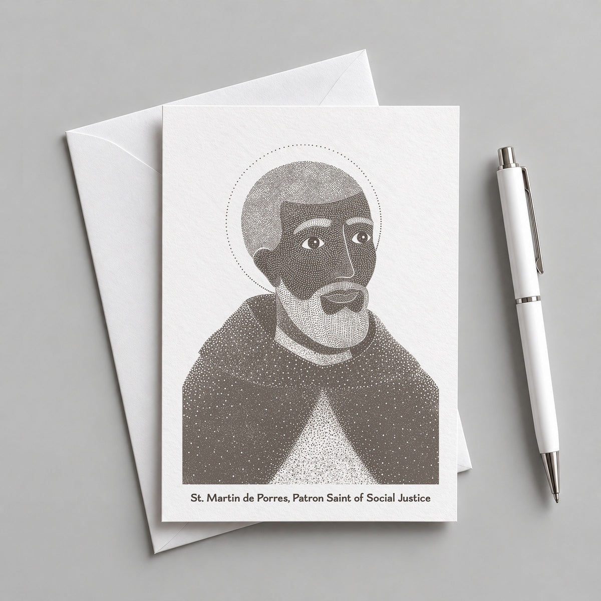 Brown St Martin de Porres card with an envelope and pen