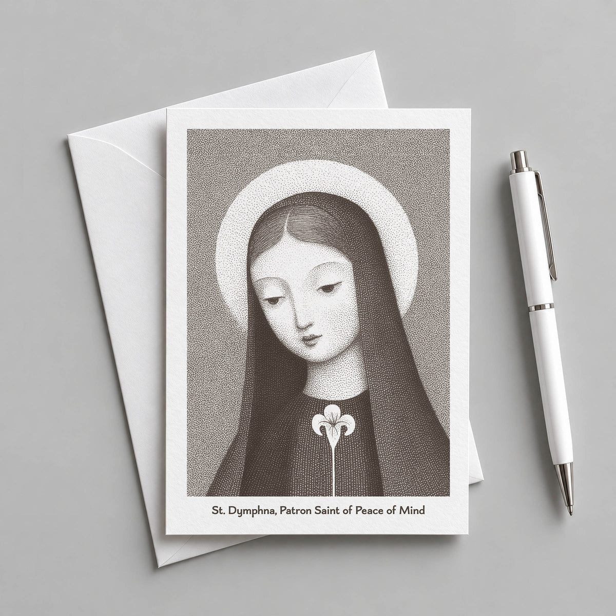 Brown St Dymphna card with an envelope and pen