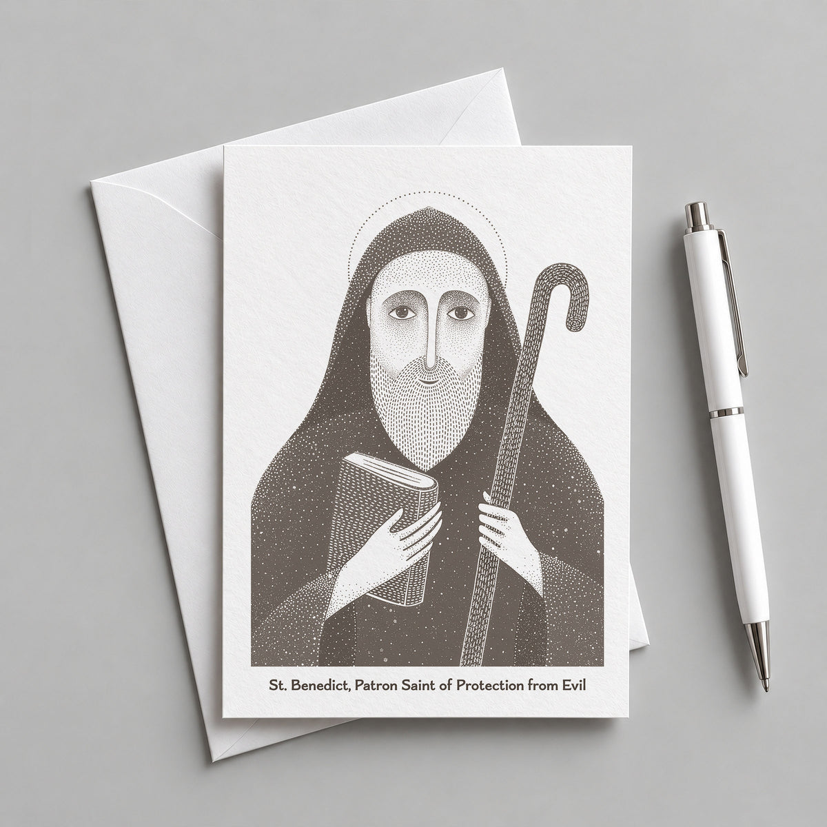 Brown St Benedict card with an envelope and pen