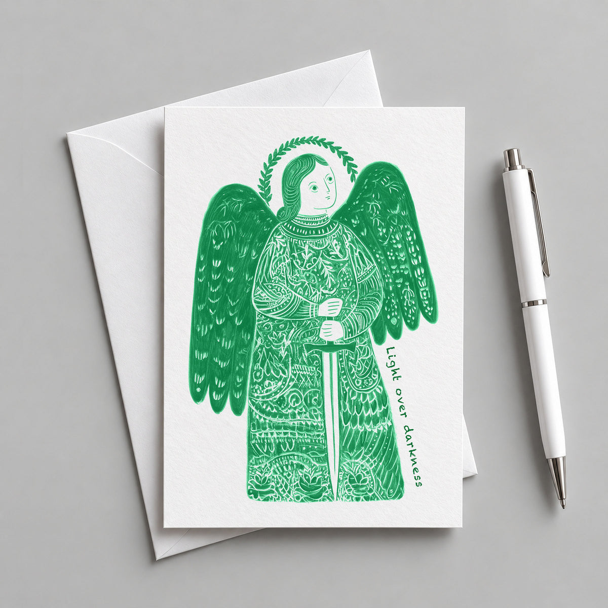 Green St Michael the Archangel card with an envelope and pen