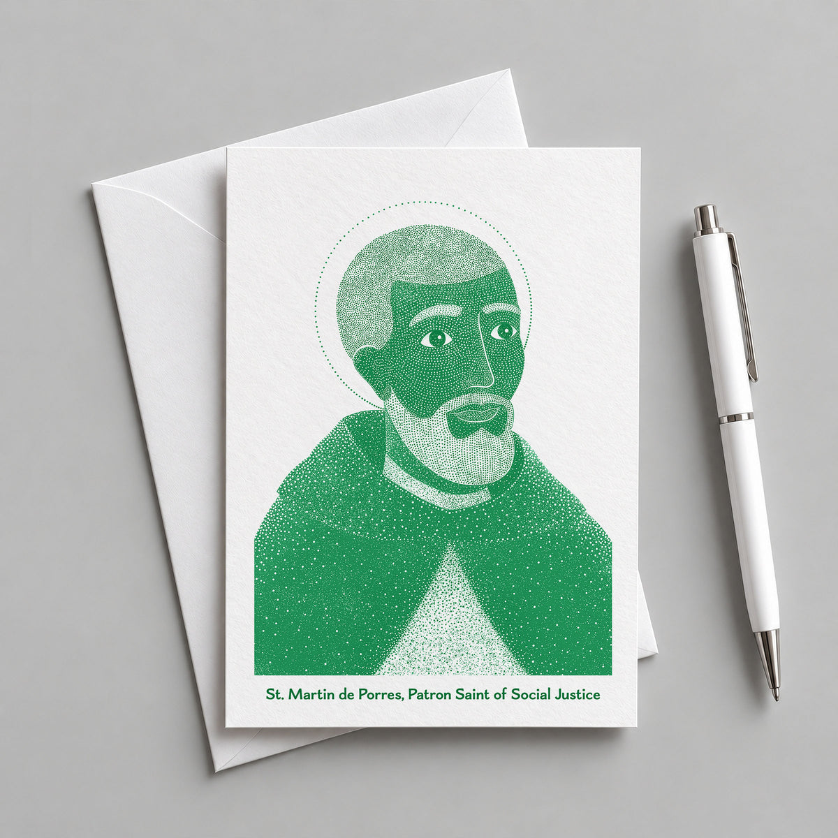 Green St Martin de Porres card with an envelope and pen