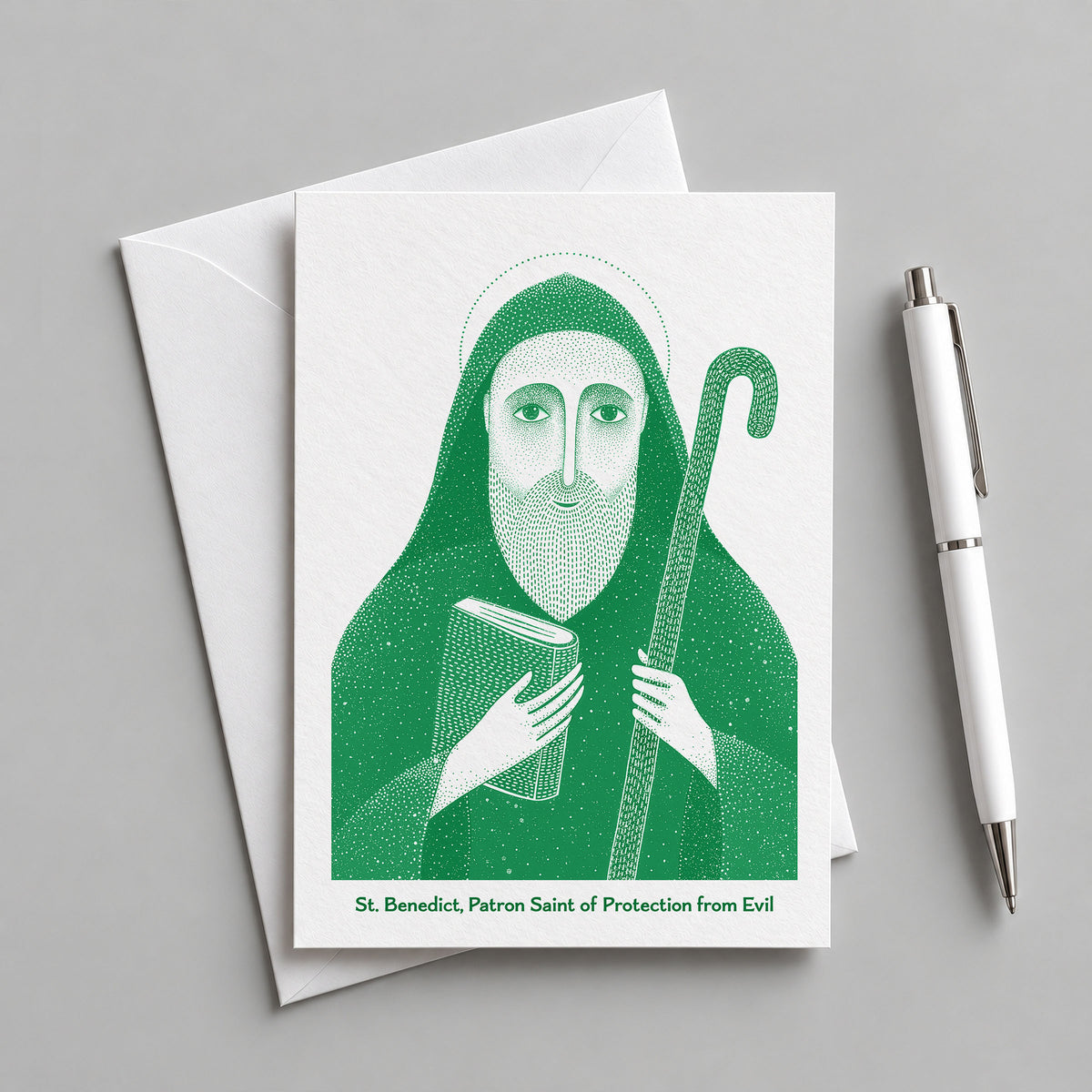 Green St Benedict card with an envelope and pen
