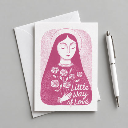 Pink St. Thérèse of Lisieux card with an envelope and pen