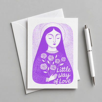 Purple St. Thérèse of Lisieux card with an envelope and pen