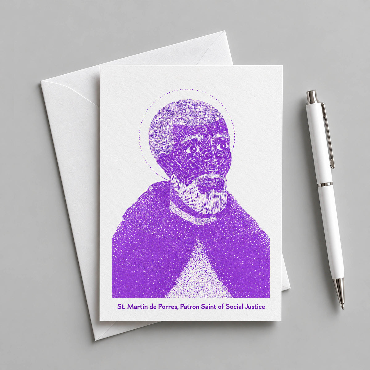Purple St Martin de Porres card with an envelope and pen