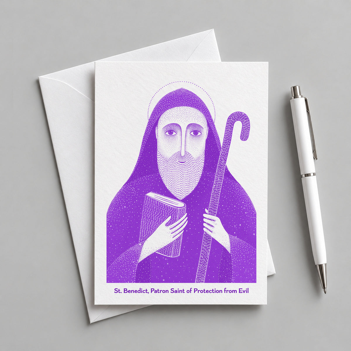 Purple St Benedict card with an envelope and pen