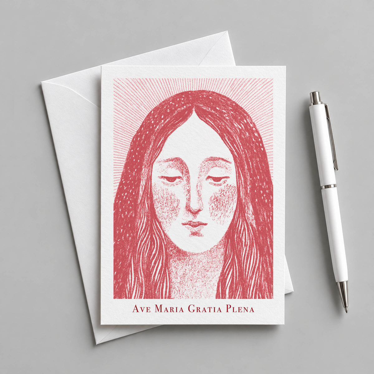 Red Virgin Mary card with an envelope and pen