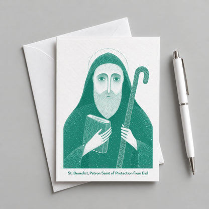 Teal St Benedict card with an envelope and pen